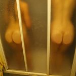 Pair of Naked Buttocks Against the Shower Cabin